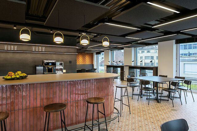Modern lounge area with bar and Matric light lines that design the room with a clear, uniform light structure